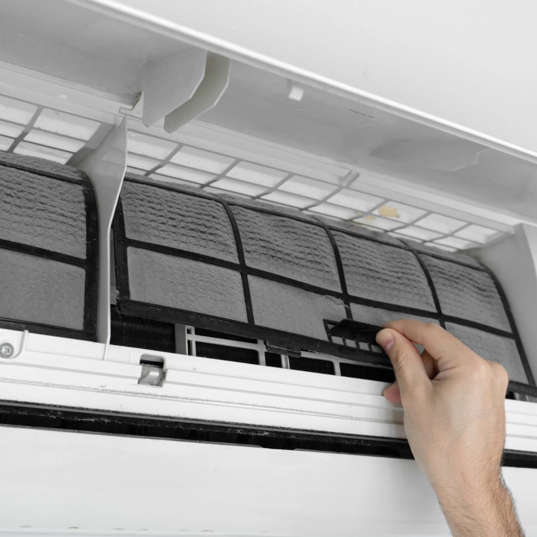 Air Conditioning expert cleaning an Air Con unit from Midlands Climate Solutions